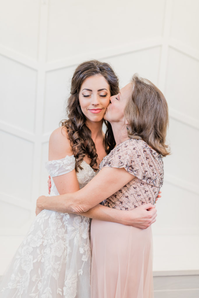 Blush Rose Gold Wedding Bride and Bridesmaids Getting Dressed Laughing Mother of the Bride | Sunset Oaks in Tyler TX by DFW Dallas Fort Worth wedding photographer Karina Danielle Photography