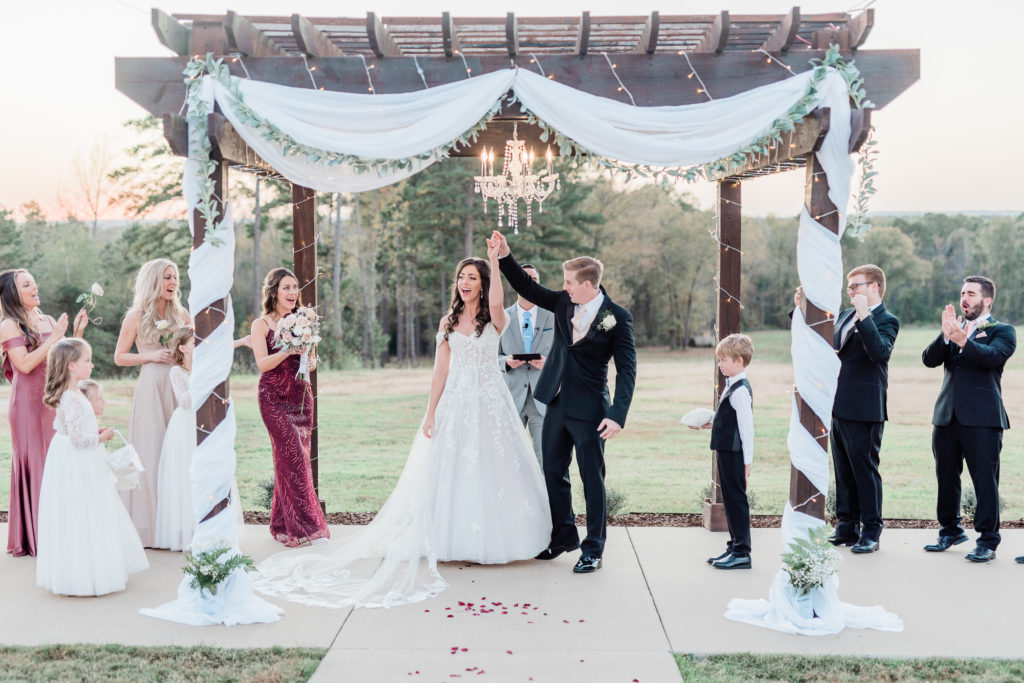 Wedding Ceremony Bride and Groom Cheering Fall Blush Rose Gold Pink Wine Wedding | Sunset Oaks in Tyler TX by DFW Dallas Fort Worth wedding photographer Karina Danielle Photography