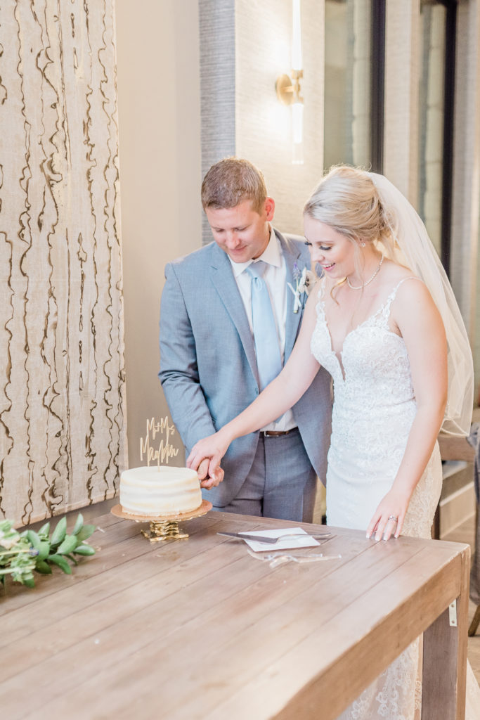 Bride and Groom Cutting Wedding Cake Reception | Stonehouse Villa in Driftwood TX by DFW Dallas Fort Worth wedding photographer Karina Danielle Photography