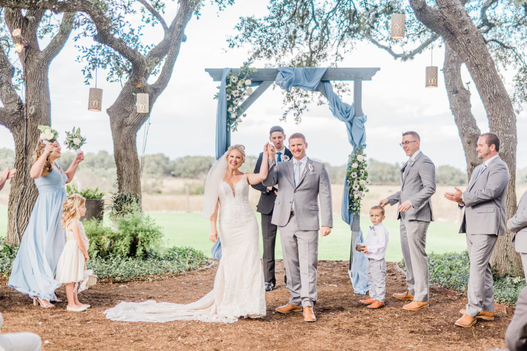 Wedding Ceremony Recessional Dusty Blue Arch | Stonehouse Villa in Driftwood TX by DFW Dallas Fort Worth wedding photographer Karina Danielle Photography