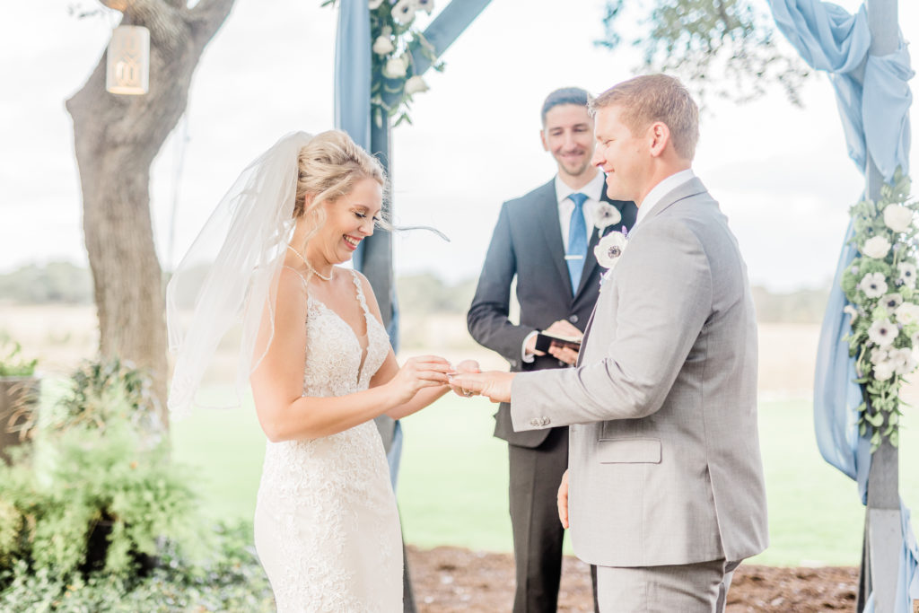 Wedding Ceremony Ring Exchange Dusty Blue Arch | Stonehouse Villa in Driftwood TX by DFW Dallas Fort Worth wedding photographer Karina Danielle Photography
