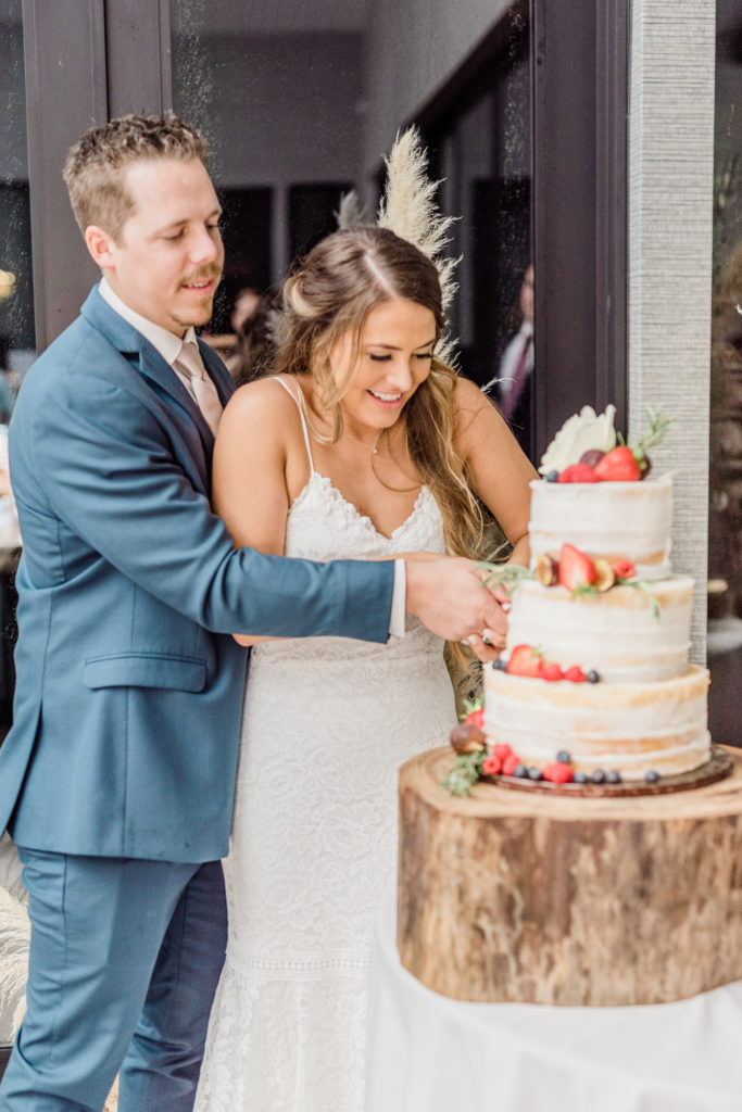 Bride and Groom Cut Cake Reception | Stonehouse Villa in Driftwood TX by DFW Dallas Fort Worth wedding photographer Karina Danielle Photography