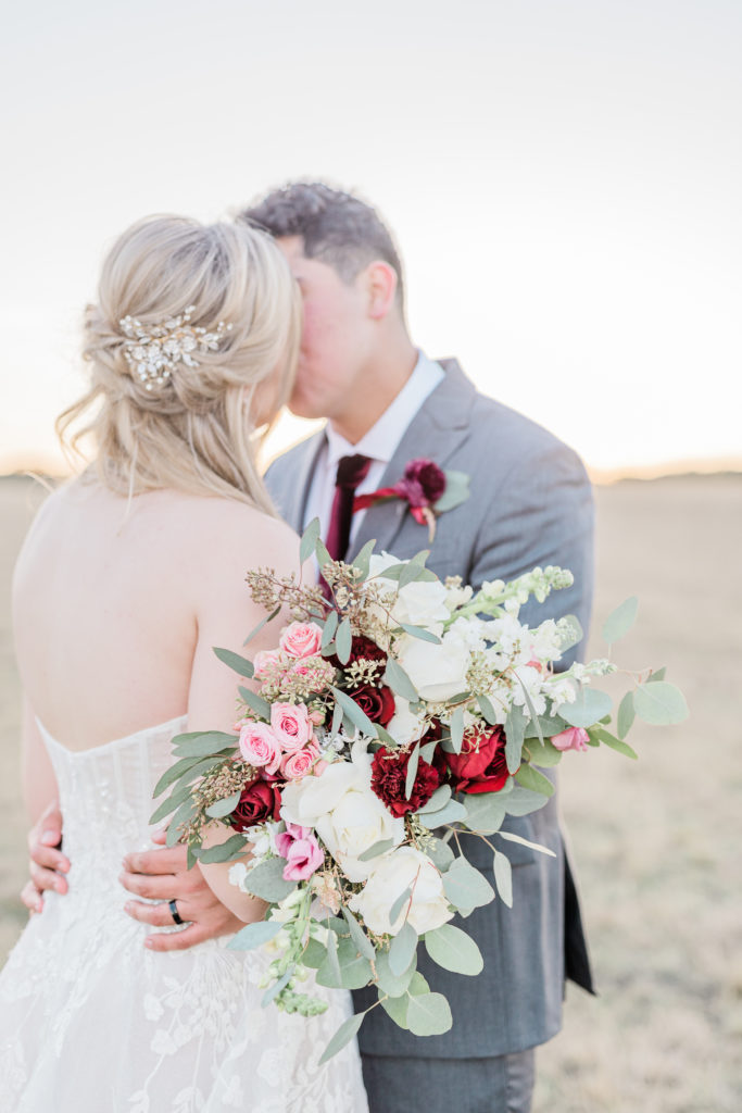 Bride and Groom Portrait Strapless Dress Grey Suit Velvet Tie Blush and Wine Bouquet Eucalyptus | Wagon Springs Ranch in Burnet TX by DFW Dallas Fort Worth wedding photographer Karina Danielle Photography