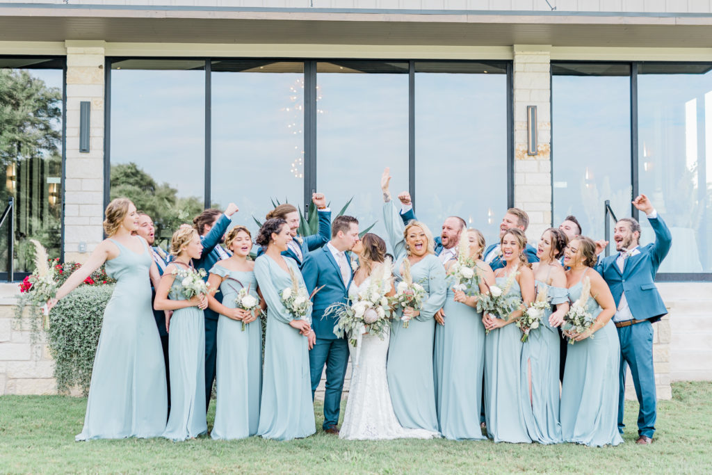 Bride and Groom Bridesmaids Groomsmen Wedding Party Dusty Blue Dresses Pampas Grass Bouquet Navy Suit Boho | Stonehouse Villa in Driftwood TX by DFW Dallas Fort Worth wedding photographer Karina Danielle Photography