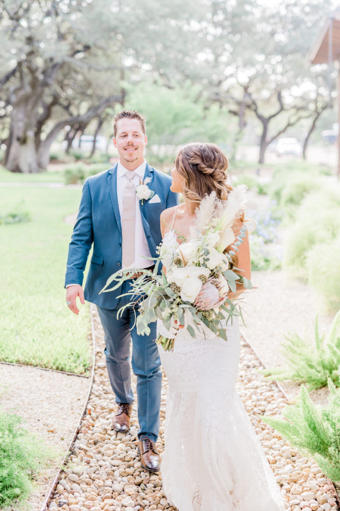 Bride and Groom Portraits Lace Dress Navy Suit Pampas Grass Bouquet Boho | Stonehouse Villa in Driftwood TX by DFW Dallas Fort Worth wedding photographer Karina Danielle Photography