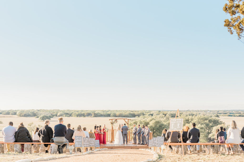 Bride and Groom Ceremony Strapless Dress Grey Suit Velvet Tie Blush and Wine Bouquet Eucalyptus | Wagon Springs Ranch in Burnet TX by DFW Dallas Fort Worth wedding photographer Karina Danielle Photography