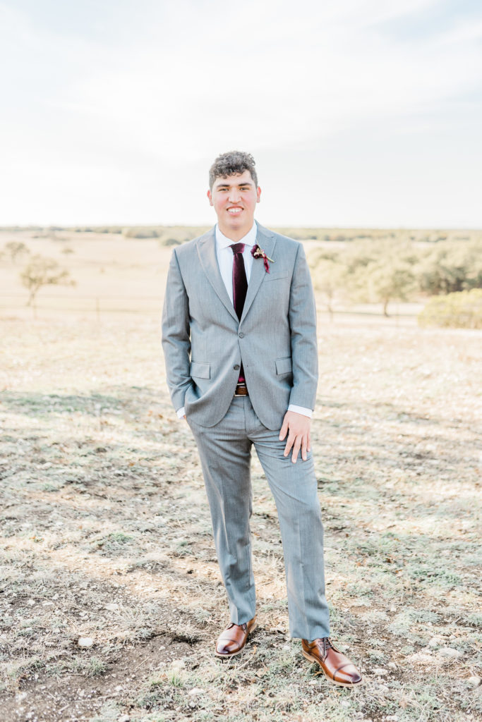 Groom Portrait Grey Suit Velvet Tie | Wagon Springs Ranch in Burnet TX by DFW Dallas Fort Worth wedding photographer Karina Danielle Photography