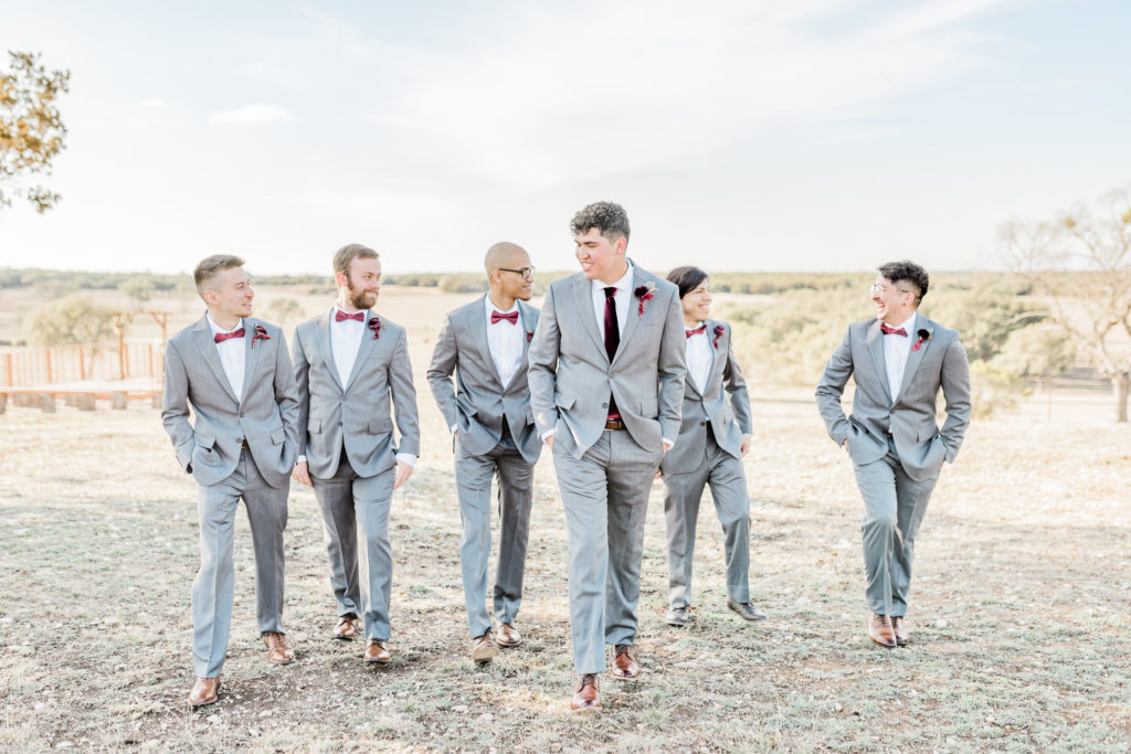 Bridal Party Groomsmen Groom Portrait Grey Suit Velvet Tie | Wagon Springs Ranch in Burnet TX by DFW Dallas Fort Worth wedding photographer Karina Danielle Photography