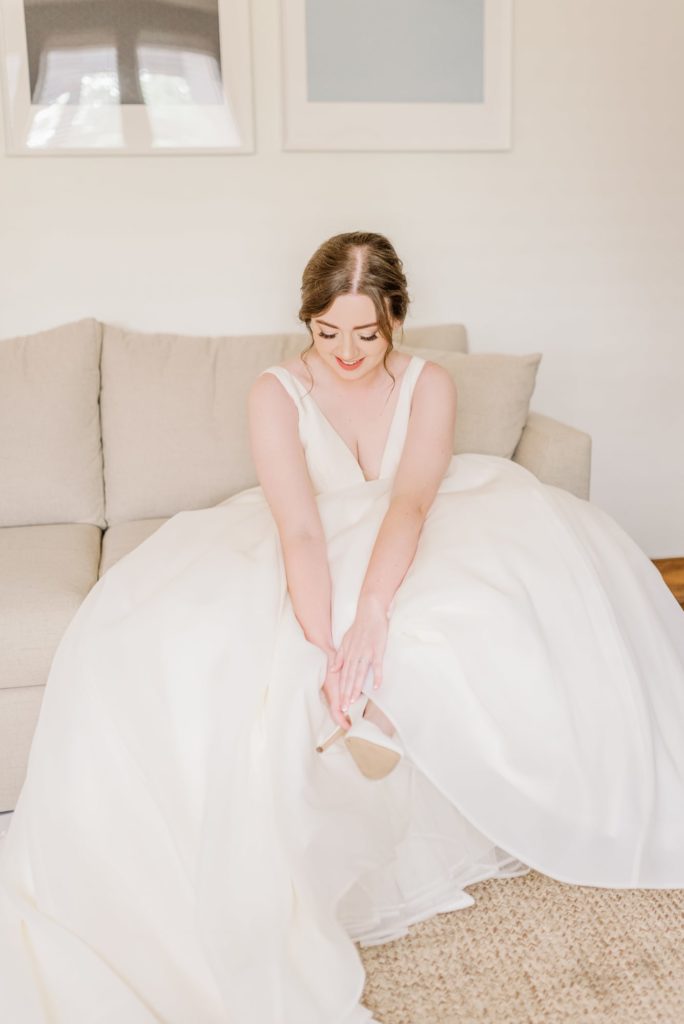 Bride Putting on Heels | Carleen Bright Arboretum in Waco TX by DFW Dallas wedding photographer Karina Danielle Photography