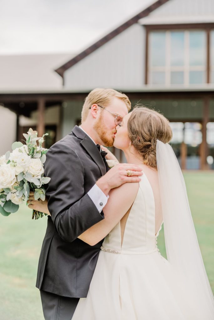 Engaged Couple Sharing a Kiss | Carleen Bright Arboretum in Waco TX by DFW Dallas wedding photographer Karina Danielle Photography