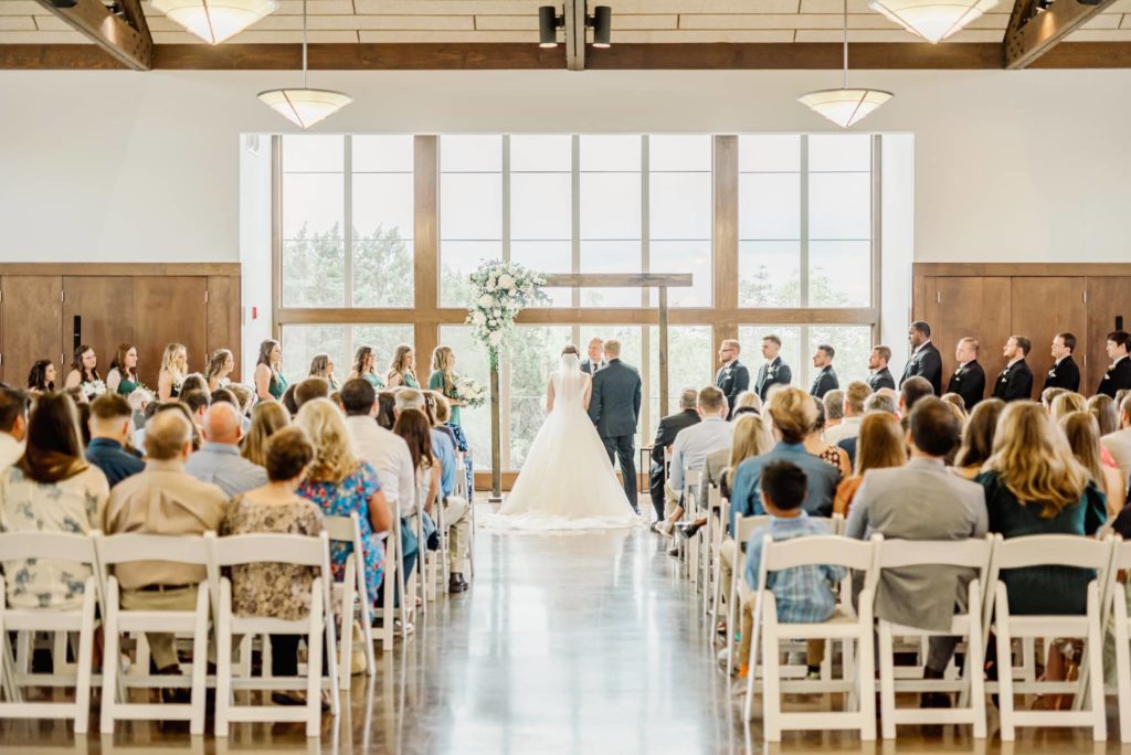 Ceremony Aisle with Couple Under Arch | Carleen Bright Arboretum in Waco TX by DFW Dallas wedding photographer Karina Danielle Photography