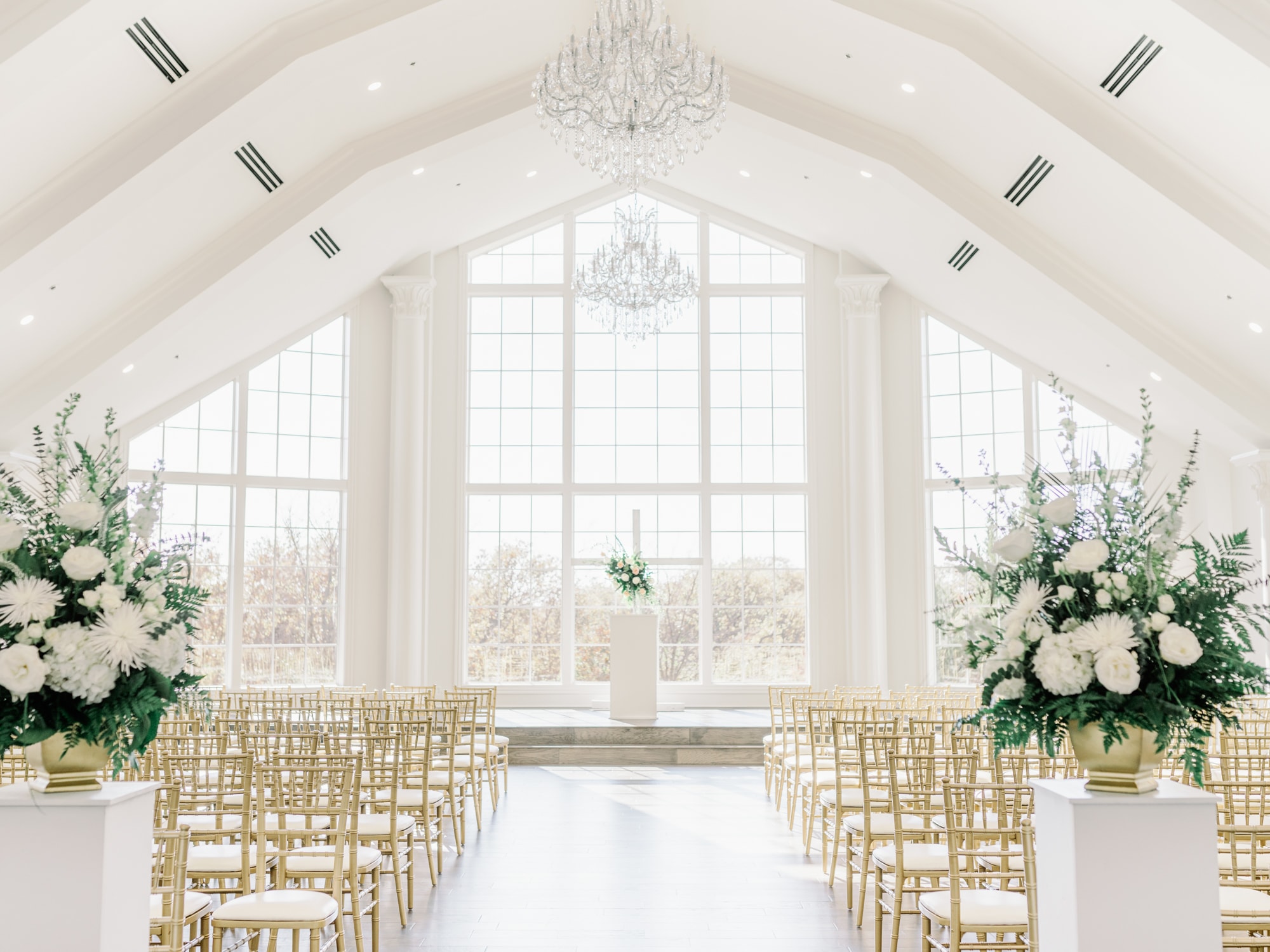 Empty and decorated ceremony space at The Hillside Estate with tall windows