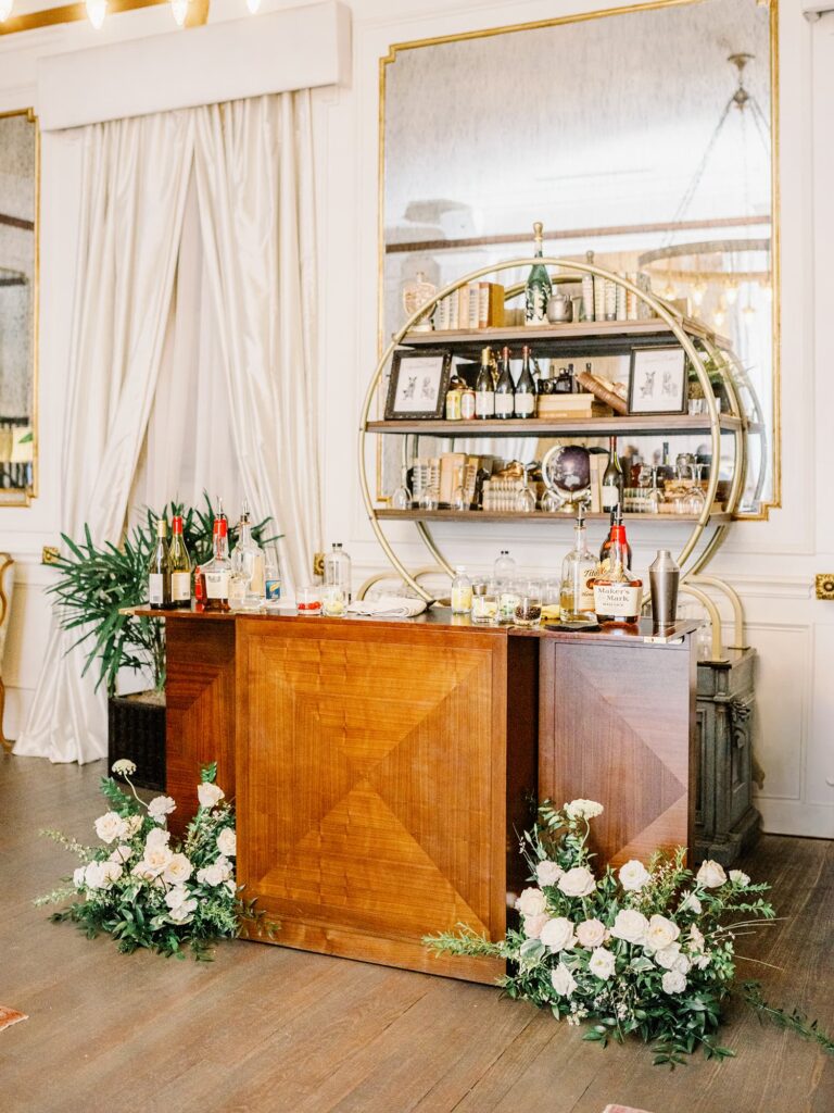 The drawing room at the Mason Dallas with bar and white rose florals.