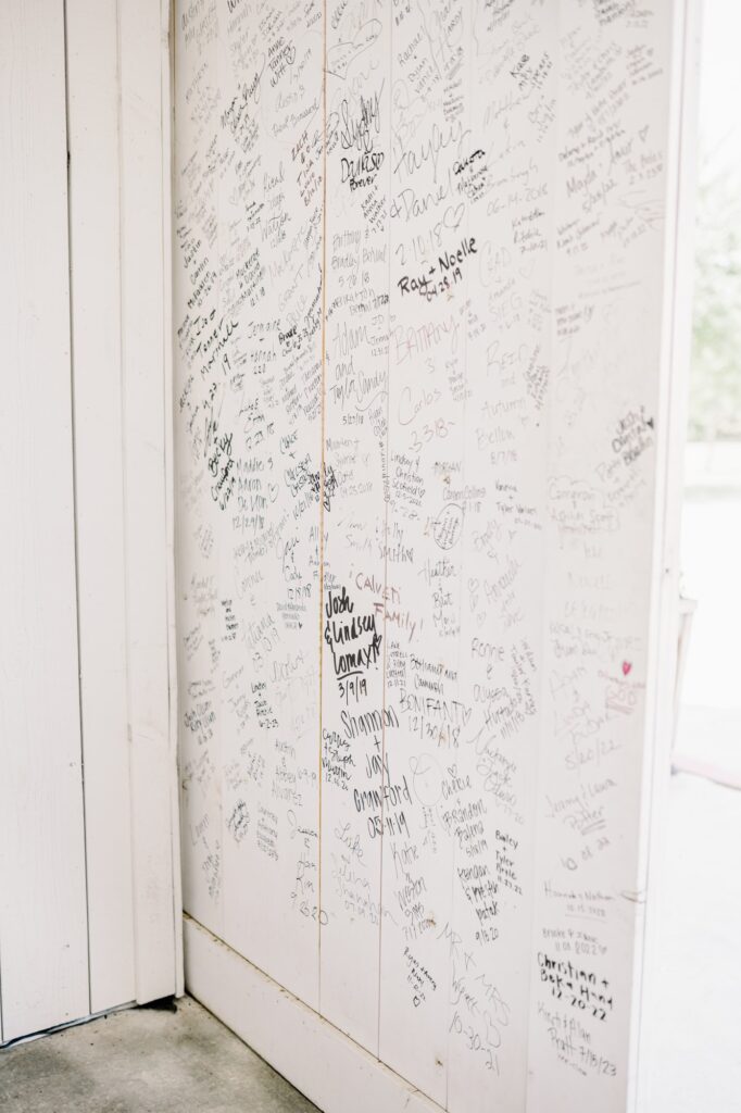 Barn doors at the Nest at Ruth Farms with signatures of couples who had their Dallas wedding there.