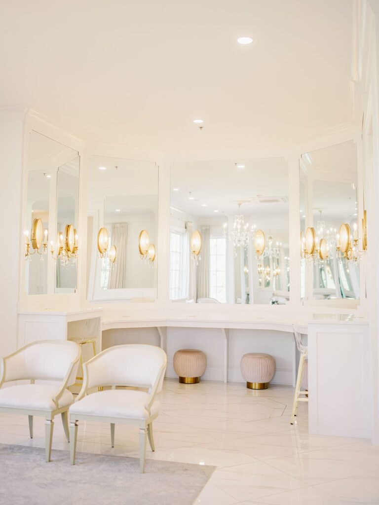 Bridal suite at the Hillside Estate with hair and makeup stations and golden chandeliers.