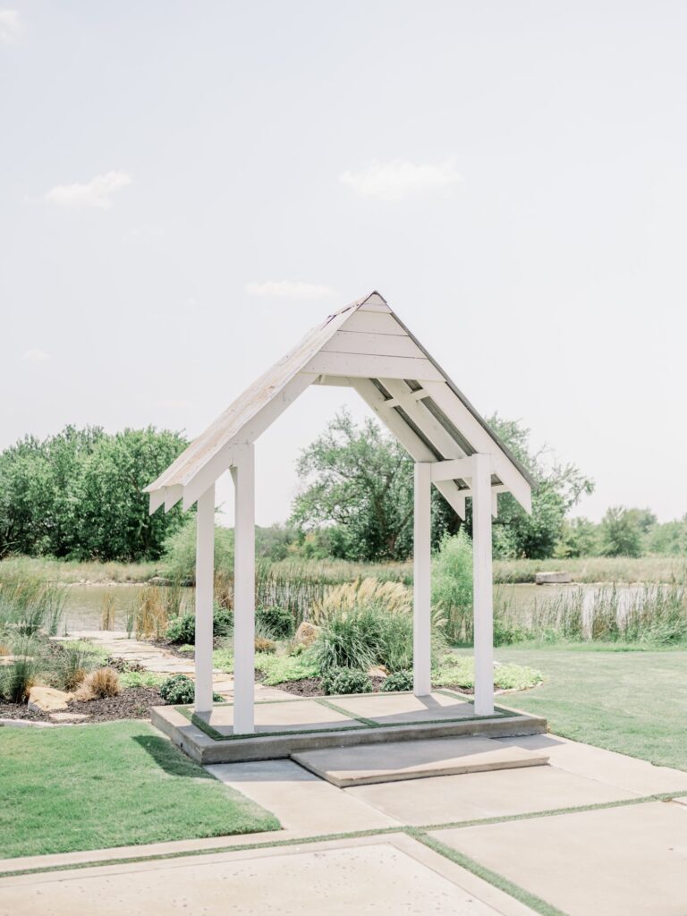 Outdoor ceremony space at The Nest at Ruth Farms with pond and greenery.