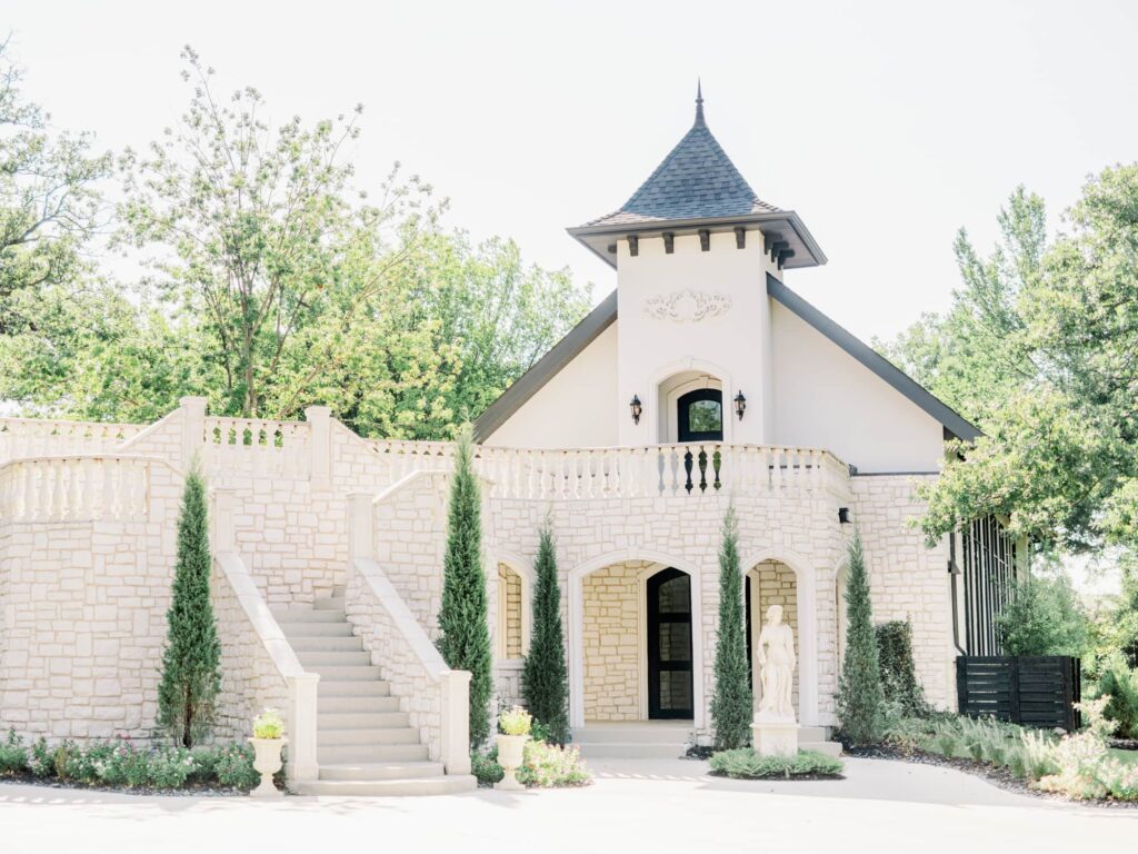 White washed brick wedding chapel with greenery and landscaping at Brighton Abbey in Dallas.